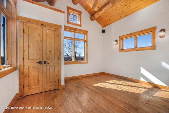 foyer featuring wooden ceiling, vaulted ceiling with beams, and hardwood / wood-style floors