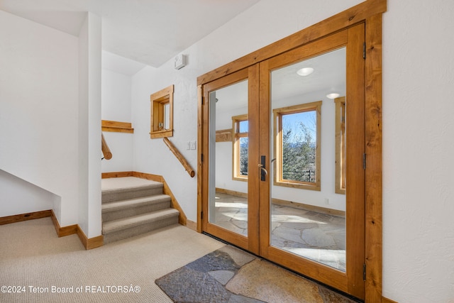 doorway to outside with french doors and light colored carpet