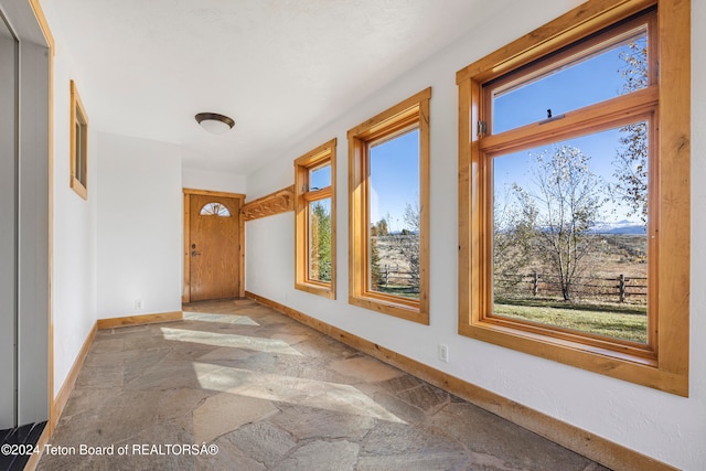 corridor featuring a wealth of natural light