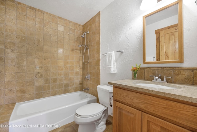 full bathroom featuring a textured ceiling, toilet, tiled shower / bath, vanity, and decorative backsplash