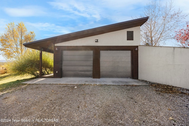 garage featuring a carport