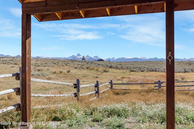 view of yard with a mountain view and a rural view