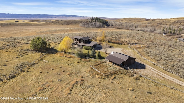 drone / aerial view featuring a mountain view and a rural view