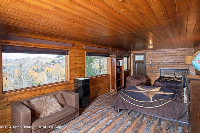 bedroom featuring lofted ceiling, wooden walls, hardwood / wood-style flooring, wooden ceiling, and a mountain view