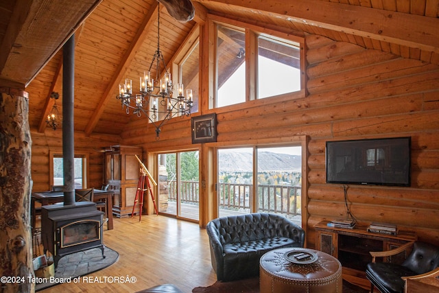 living room with beamed ceiling, high vaulted ceiling, wood ceiling, a wood stove, and light wood-type flooring