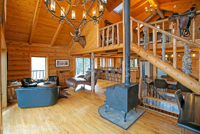 living room featuring wood-type flooring, wooden ceiling, a wood stove, and beam ceiling