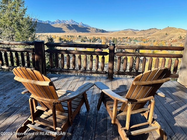 wooden deck featuring a mountain view