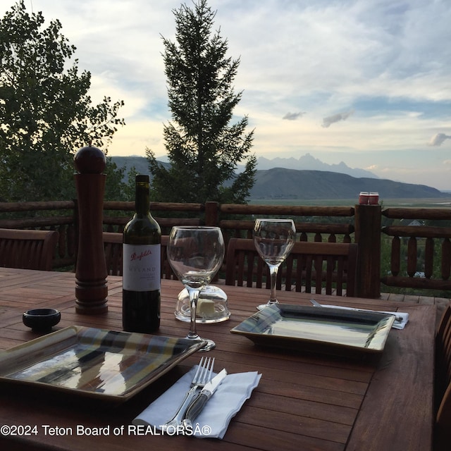 deck at dusk featuring a mountain view