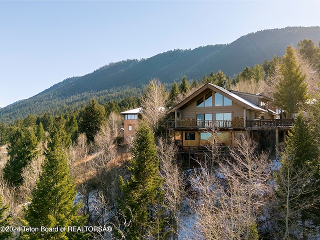 back of house with a deck with mountain view