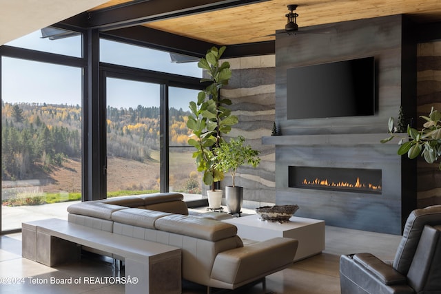 living room with a large fireplace and wood ceiling