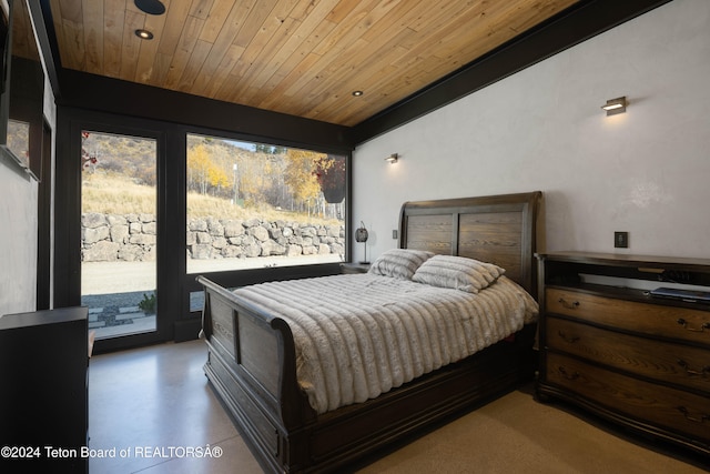 bedroom with access to exterior, concrete flooring, and wood ceiling