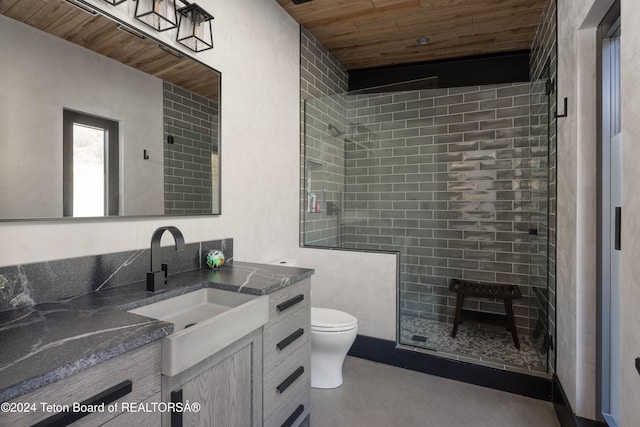 bathroom featuring vanity, wooden ceiling, toilet, a tile shower, and concrete flooring