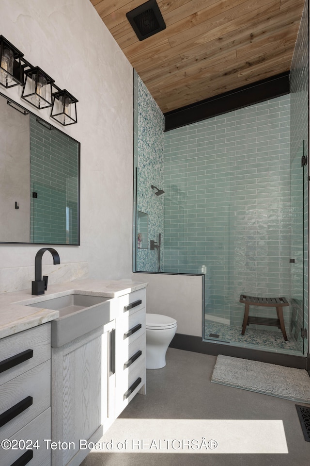 bathroom with tiled shower, vanity, wood ceiling, and toilet