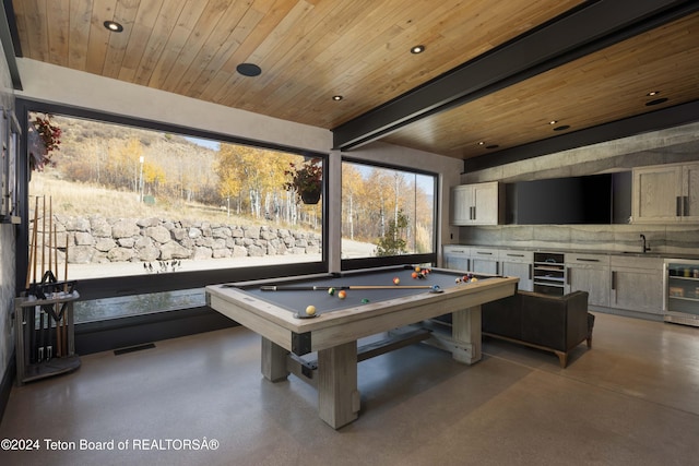 recreation room featuring wine cooler, billiards, concrete floors, and wood ceiling