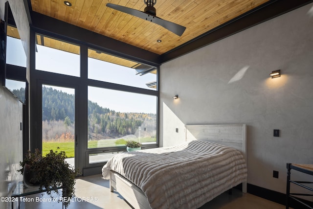 bedroom featuring concrete floors, vaulted ceiling, ceiling fan, and wood ceiling