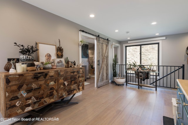 interior space featuring a barn door and light hardwood / wood-style flooring