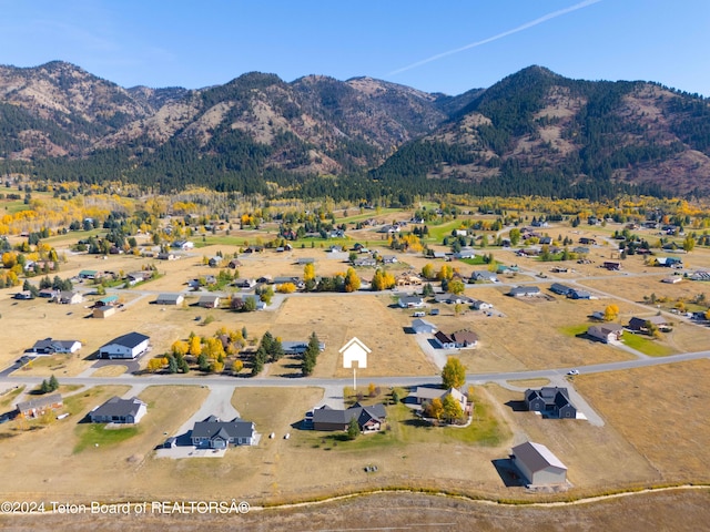 birds eye view of property with a mountain view