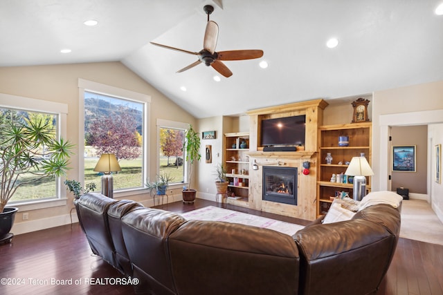 living room with dark hardwood / wood-style floors, ceiling fan, and vaulted ceiling