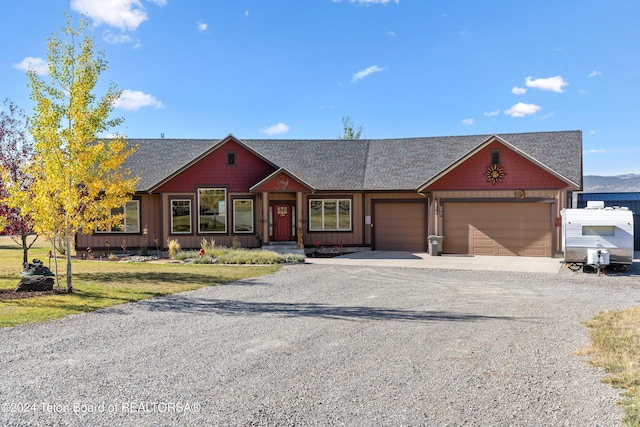 ranch-style house featuring a front yard and a garage