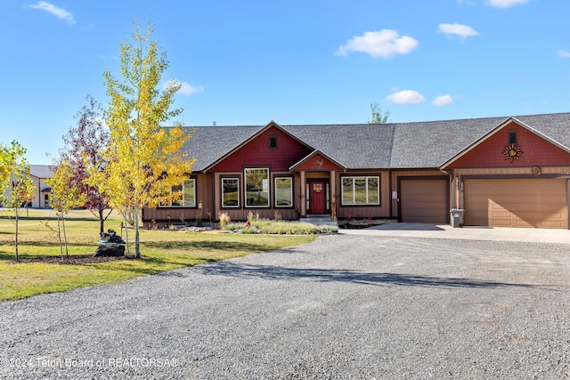 ranch-style house featuring a garage and a front yard