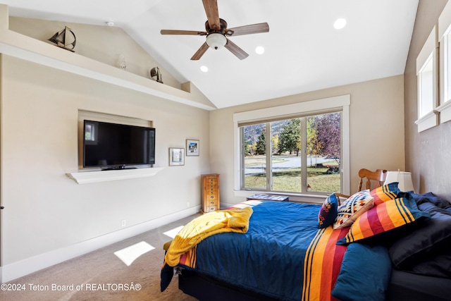 carpeted bedroom featuring ceiling fan and vaulted ceiling