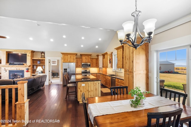 dining room featuring dark hardwood / wood-style flooring, an inviting chandelier, high vaulted ceiling, and sink