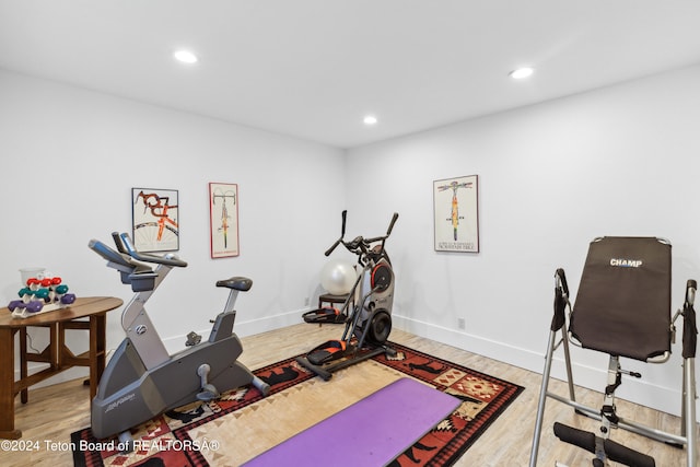 exercise area featuring hardwood / wood-style flooring