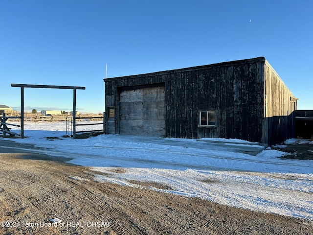 8 S Kicking Bird Rd, Pinedale, WY 82941 - snow covered structure with an outbuilding