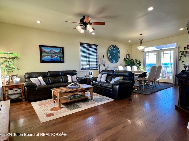 living room with french doors, dark wood-type flooring, and ceiling fan