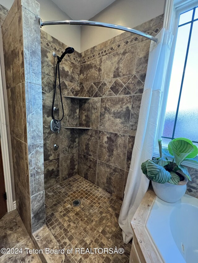 8 S Kicking Bird Rd, Pinedale, WY 82941 - bathroom featuring a tile shower and a tub to relax in