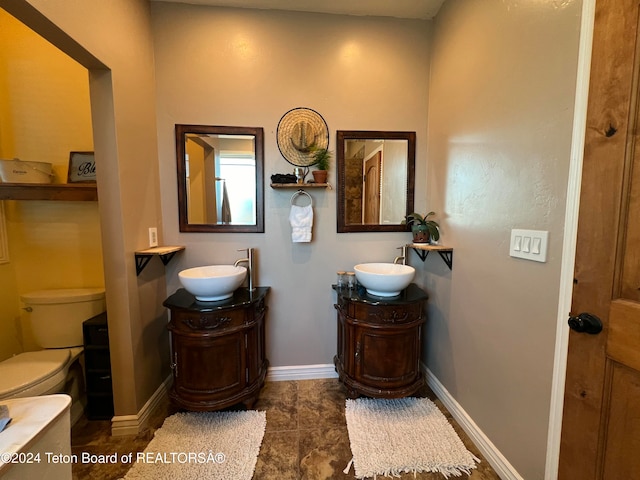 bathroom featuring tile patterned flooring, vanity, and toilet