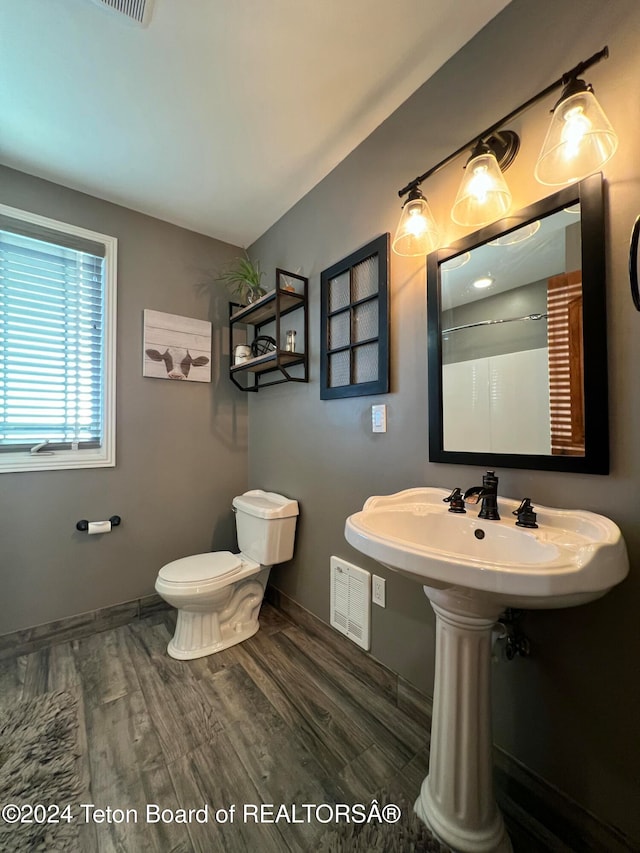 bathroom featuring walk in shower, sink, toilet, and hardwood / wood-style floors