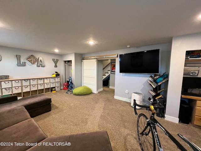 carpeted living room with a barn door