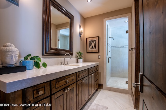 bathroom featuring walk in shower, vanity, and tile patterned floors