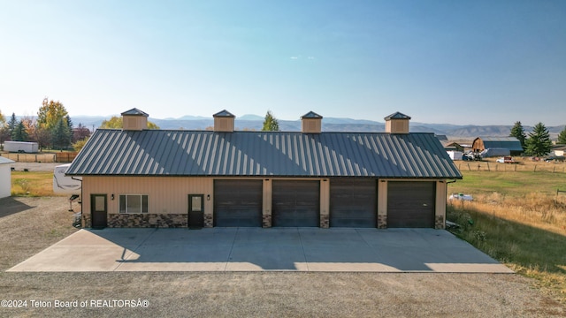 view of front of home with a mountain view and a garage