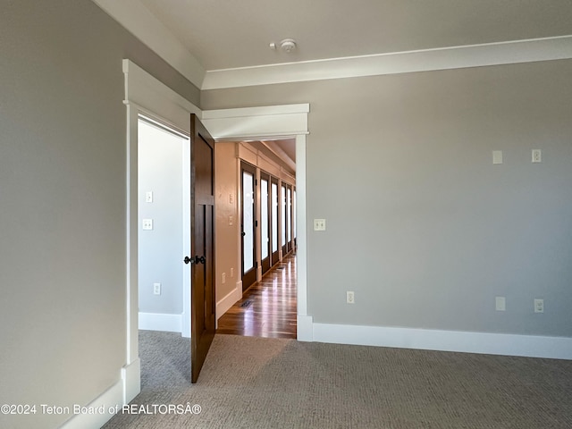 spare room featuring dark colored carpet