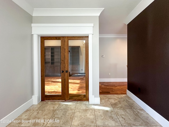 entryway featuring crown molding, french doors, and light hardwood / wood-style floors