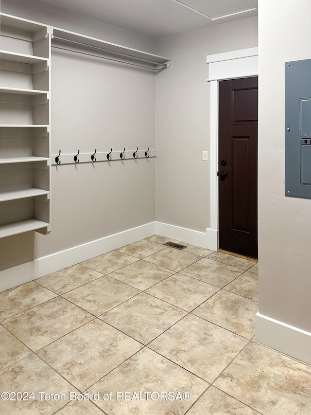 mudroom featuring light tile patterned floors and electric panel