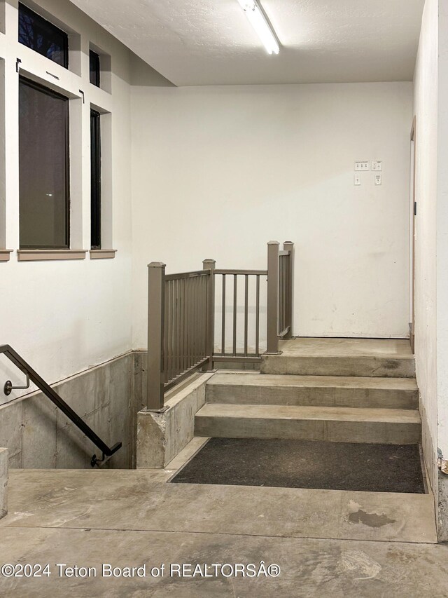 stairway with a textured ceiling