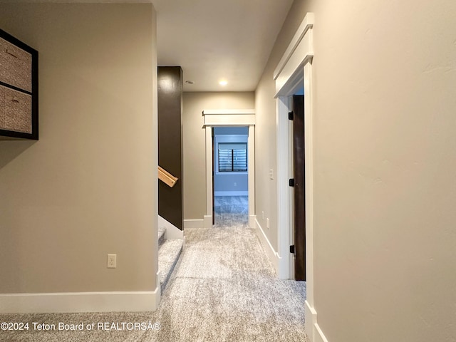 hallway featuring light carpet