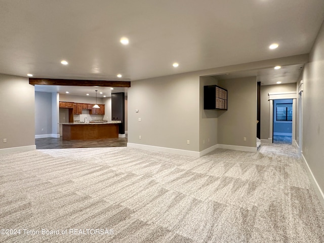 unfurnished living room with light colored carpet