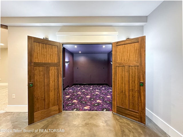 hall featuring concrete flooring