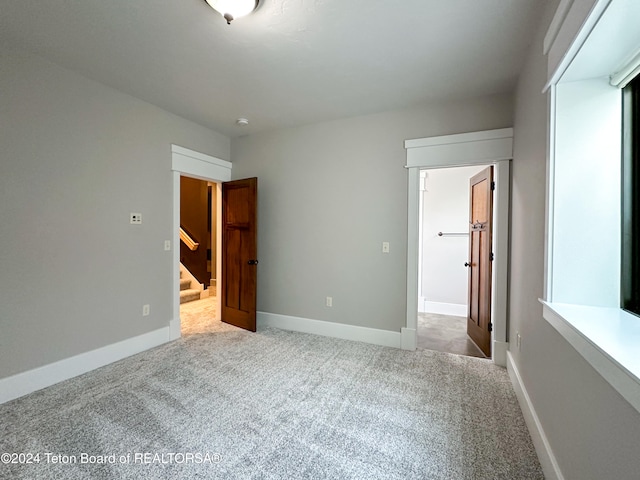 unfurnished bedroom with light carpet