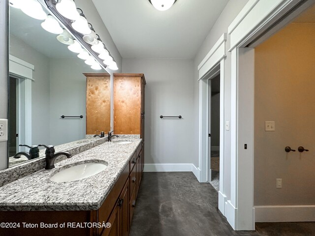 bathroom with vanity and concrete floors