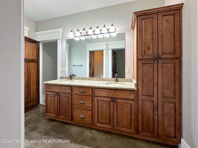 bathroom with vanity and concrete flooring