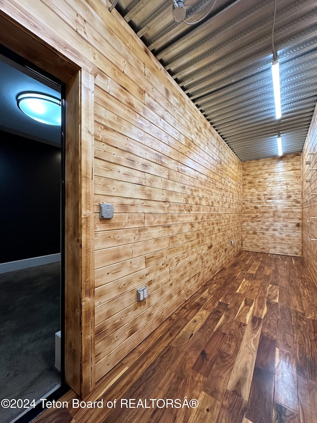 interior space featuring hardwood / wood-style floors and wooden walls