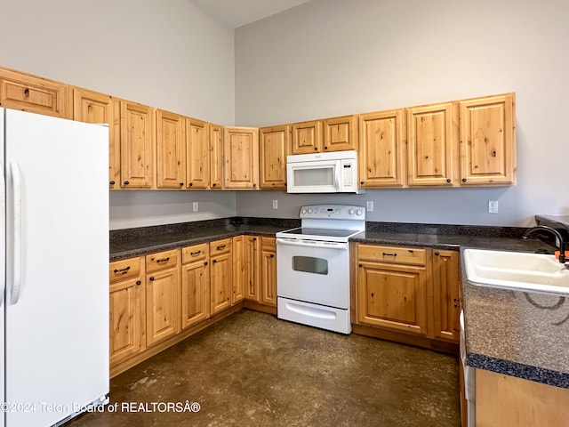 kitchen with a high ceiling, white appliances, and sink