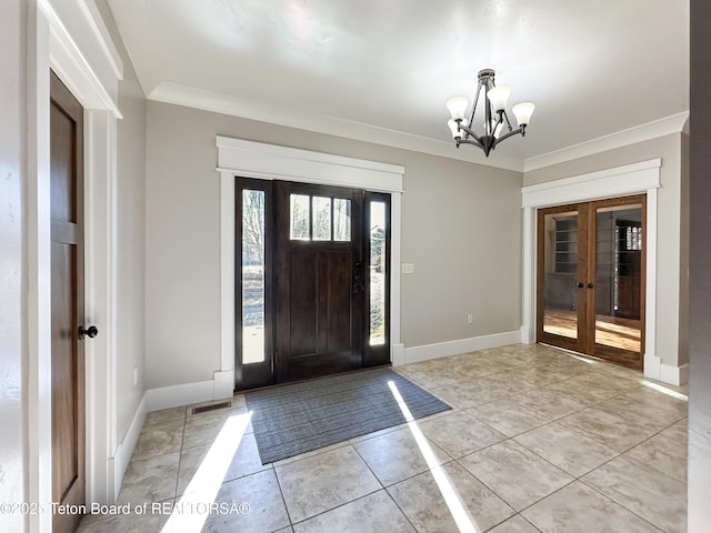 81 Twin Cliffs Rd, Afton, WY 83110 - entrance foyer featuring french doors, a chandelier, ornamental molding, and light tile patterned floors