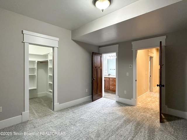 81 Twin Cliffs Rd, Afton, WY 83110 - unfurnished bedroom with light carpet, a spacious closet, a closet, and ensuite bathroom