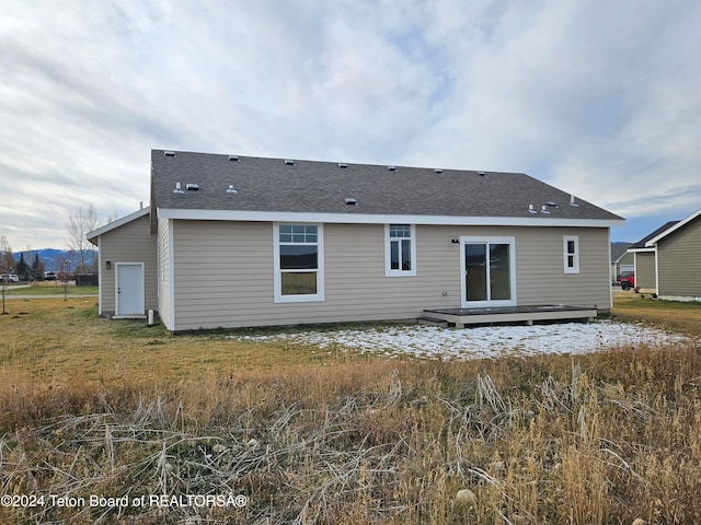 rear view of property with a wooden deck